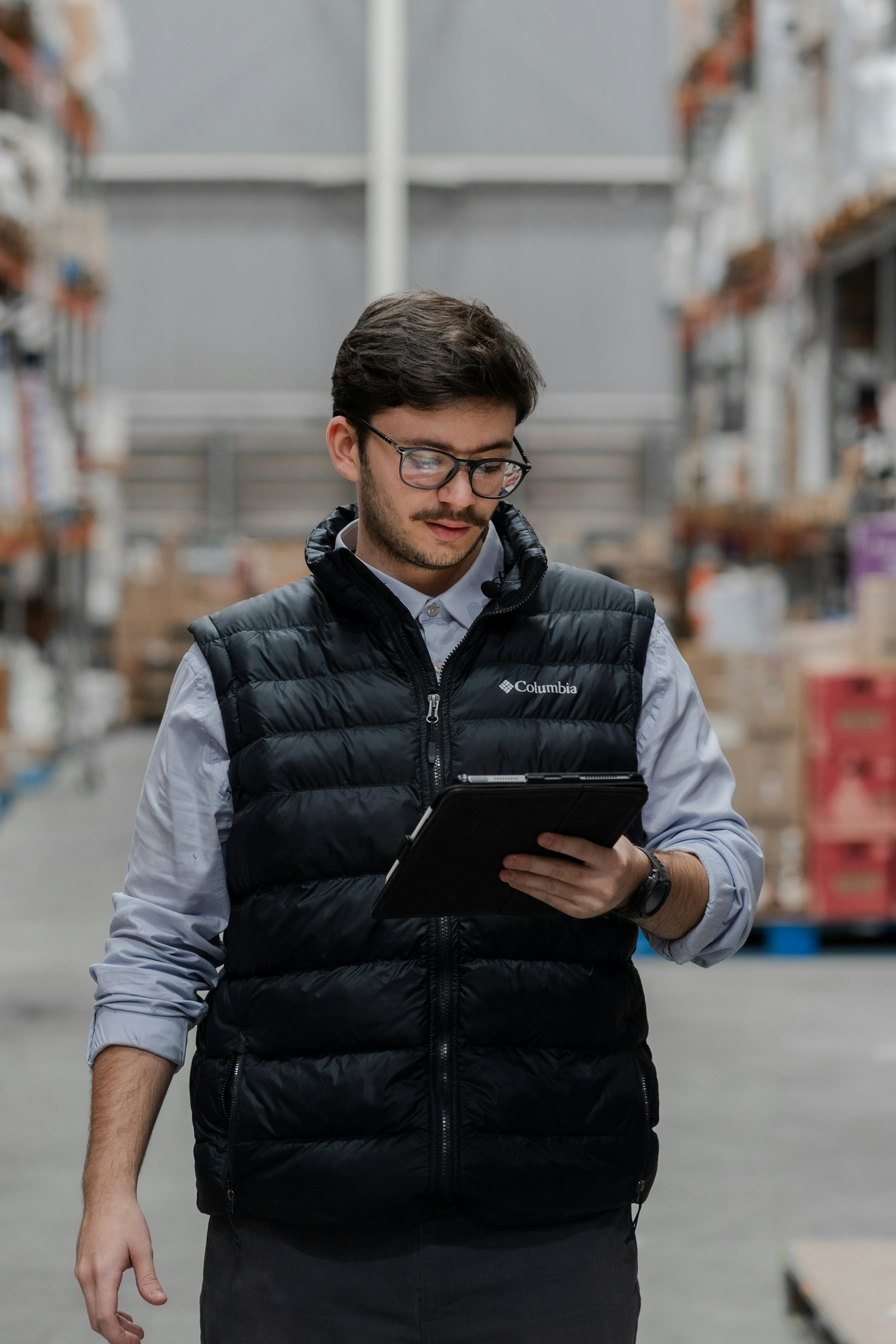 Shipment records being reviewed on a tablet in a warehouse